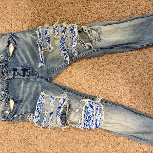 Distressed Blue Jeans with Patterned Rips - Picture 2 of 4